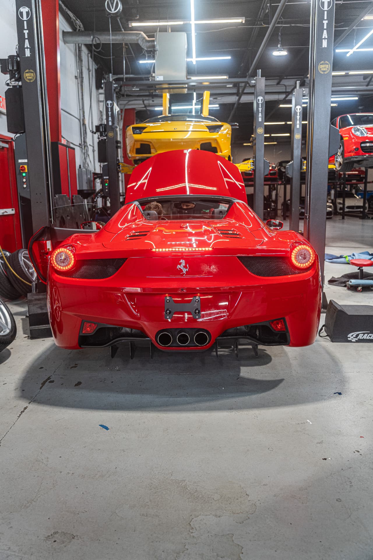 Exotic supercar on a lift inside the Velocity service atelier